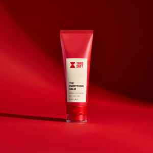 Red tube of 'The Everything Balm' by Third Shift on a red background