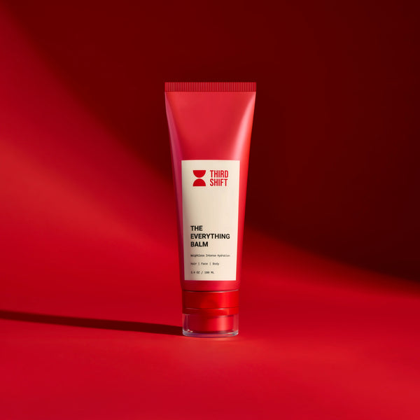 Red tube of 'The Everything Balm' by Third Shift on a red background