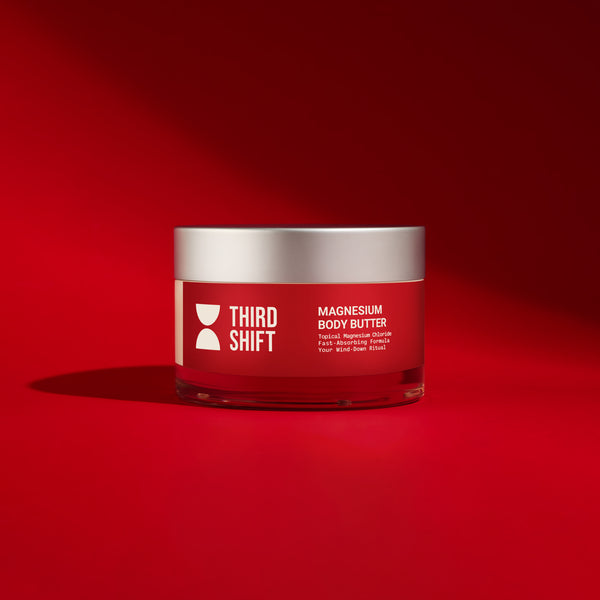 Red jar of Third Shift magnesium body butter on a red background