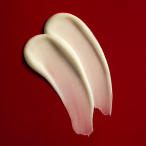 Two swatches of cream on a red background
