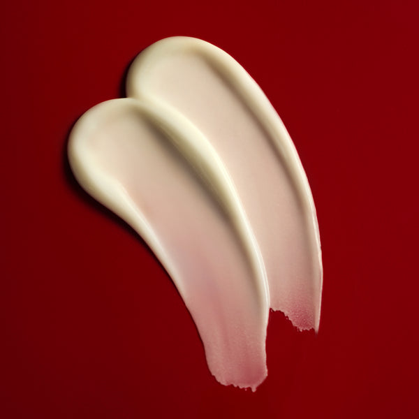 Two swatches of cream on a red background