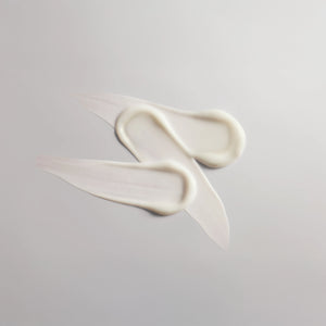 Three swatches of 'The Everything Balm' on a greyish-white background