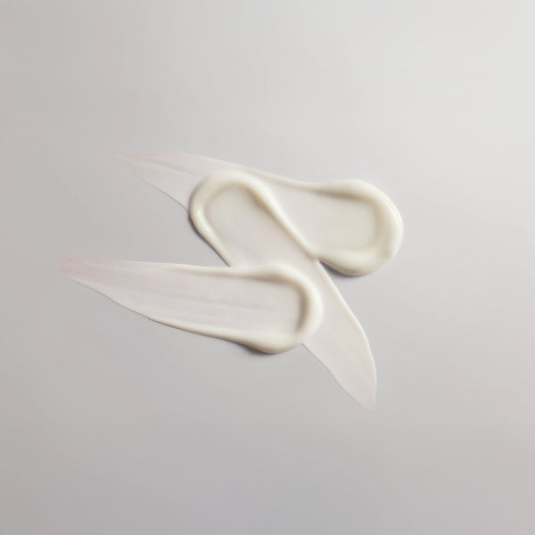 Three swatches of 'The Everything Balm' on a greyish-white background