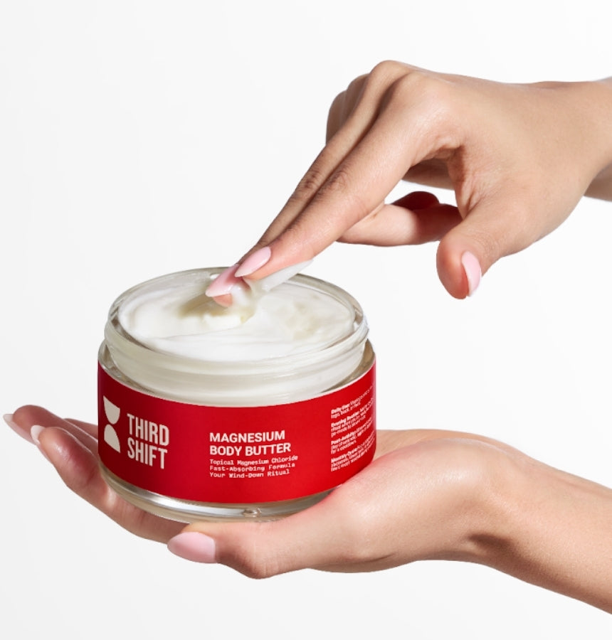 Jar of Third Shift magnesium body butter with a hand applying the cream.